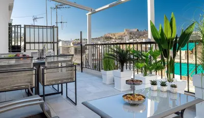 a balcony with a table and some plants on it at Acropolis Views Studio in Athens