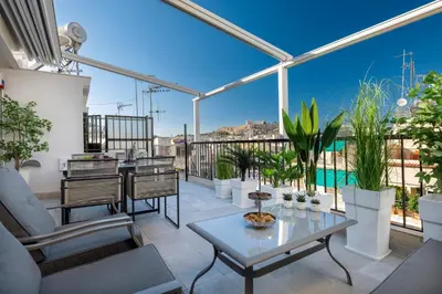 a patio with a table and chairs on a balcony at Acropolis Views Studio in Athens
