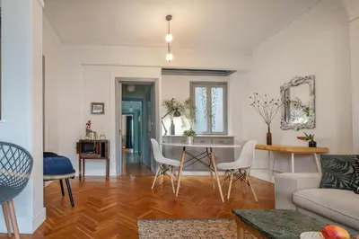 a living room with a table and white chairs at Friends & family 3broom apt, downtown Athens-FIX in Athens