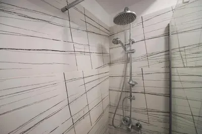 a bathroom with a shower with black and white tiles at Friends & family 3broom apt, downtown Athens-FIX in Athens