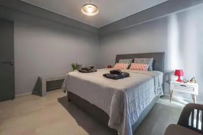 a bedroom with a large bed in a room at Beautiful apt in Glyfada Center, Papandreou Street in Athens