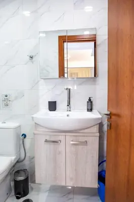 a bathroom with a sink and a mirror and a toilet at Studio apartment with all amenities in Kolonaki in Athens