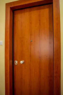 a wooden door with two knobs on it at Studio apartment with all amenities in Kolonaki in Athens