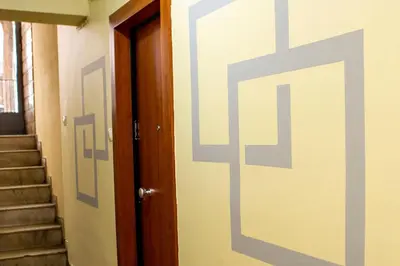 a door with a cross painted on the side of a room at Studio apartment with all amenities in Kolonaki in Athens