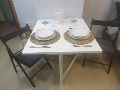 a white table with two plates and glasses on it at Studio apartment with all amenities in Kolonaki in Athens