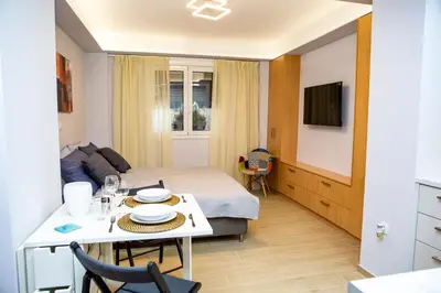 a small room with a bed and a table and a kitchen at Studio apartment with all amenities in Kolonaki in Athens