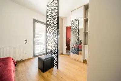 a living room with a mirror in a room at Sky Apt Unique, Spotless, 2BR, 2BA, Stunning View in Athens