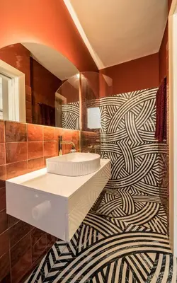 a bathroom with a black and white patterned wall at Sky Apt Unique, Spotless, 2BR, 2BA, Stunning View in Athens