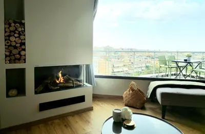a living room with a fireplace and a bed at Sky Apt Unique, Spotless, 2BR, 2BA, Stunning View in Athens