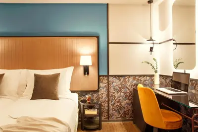 a hotel room with a bed and a desk at Zeus Essence Athens Central, former Athens Key in Athens
