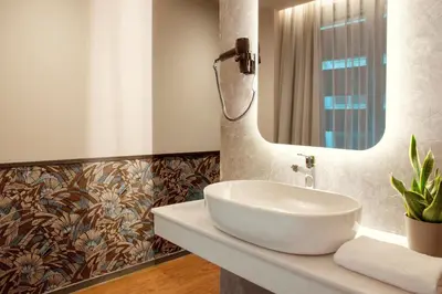 a bathroom with a sink and a mirror at Zeus Essence Athens Central, former Athens Key in Athens