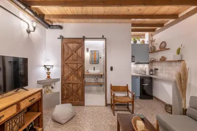a kitchen and living room with a sliding barn door at Stoa Kairi Loft B in Athens