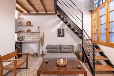 a living room with a couch and a table at Stoa Kairi Loft B in Athens