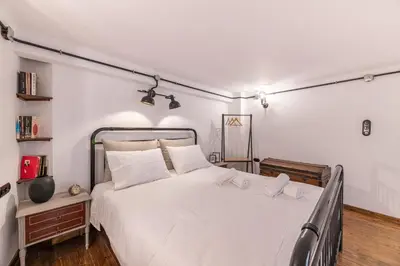 a bedroom with a large white bed with two white pillows at Stoa Kairi Loft B in Athens
