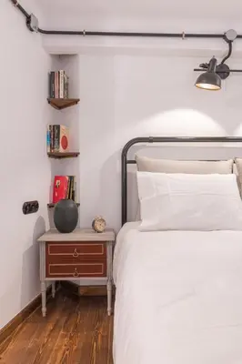 a bedroom with a bed and a nightstand next to a bed at Stoa Kairi Loft B in Athens