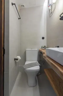 a bathroom with a white toilet and a sink at Stoa Kairi Loft B in Athens