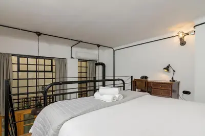 a bedroom with a bed with a towel on it at Stoa Kairi Loft B in Athens