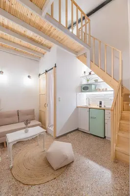 a living room with a couch and a table at Stoa Kairi Loft A in Athens