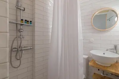 a bathroom with a sink and a shower at Stoa Kairi Loft A in Athens