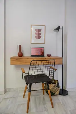 a chair sitting in front of a desk with a laptop at Luxury 2 bdroom apt- Megaro Mousikis in Athens