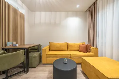 a living room with a couch and a table at Aeiphoria Suites & Rooms - Athens in Athens