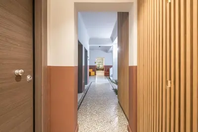 a hallway leading to the office with a long corridor at Aeiphoria Suites & Rooms - Athens in Athens