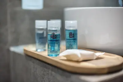 two bottles of water on a wooden cutting board at Aeiphoria Suites & Rooms - Athens in Athens