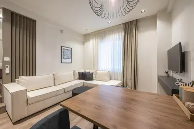a living room with a couch and a table at Aeiphoria Suites & Rooms - Athens in Athens