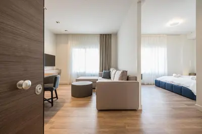 a hotel room with a bed and a couch at Aeiphoria Suites & Rooms - Athens in Athens