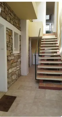 a staircase in a building with a stone wall at Brand new apartment with hidden garden in Athens