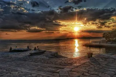 people in boats on the water at sunset at Brand new apartment with hidden garden in Athens