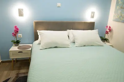 a bedroom with a large bed with white pillows at Brand new apartment with hidden garden in Athens