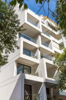 a white building with balconies on the side of it at Cubes Living Athens Goudi in Athens