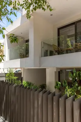 a fence in front of a house with plants at Cubes Living Athens Goudi in Athens