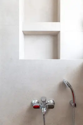 a shower head on a wall in a bathroom at Cubes Living Athens Goudi in Athens
