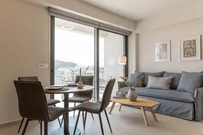 a living room with a couch and a table at Cubes Living Athens Goudi in Athens