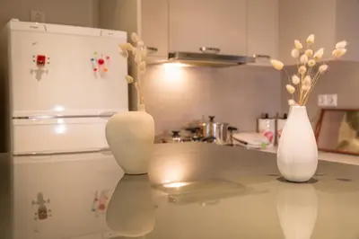 three white vases sitting on a counter in a kitchen at Lovely New Βuild Flat Near Metro - Free Parking in Athens