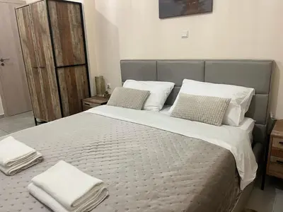 a bedroom with a large bed with towels on it at Golden Fleece Apartment VIPGreece in Athens