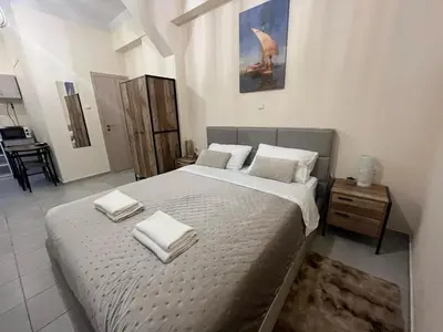 a bedroom with a large bed with towels on it at Golden Fleece Apartment VIPGreece in Athens