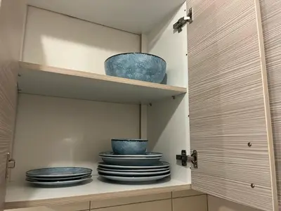 a pantry with plates and bowls on a shelf at Golden Fleece Apartment VIPGreece in Athens