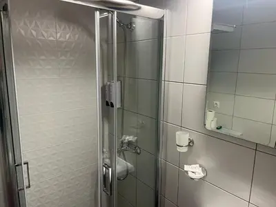 a shower with a glass door in a bathroom at Golden Fleece Apartment VIPGreece in Athens