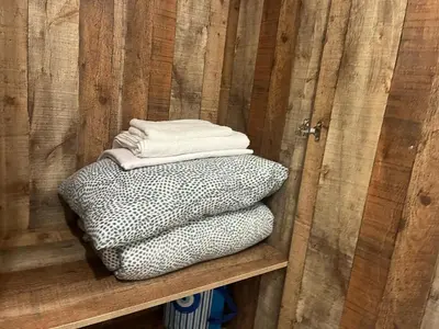 a stack of bags sitting on a shelf in a wooden wall at Golden Fleece Apartment VIPGreece in Athens