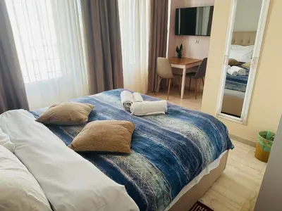 a bedroom with a large bed with two pillows at Royal Red suite No2 PIRAEUS PORT in Piraeus