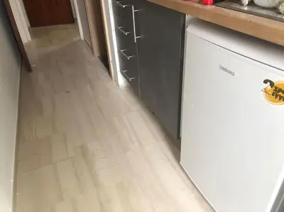 a kitchen with a wooden floor and a white dishwasher at Royal Red suite No2 PIRAEUS PORT in Piraeus