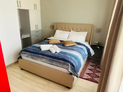 a bedroom with a bed with two towels on it at Royal Red suite No2 PIRAEUS PORT in Piraeus