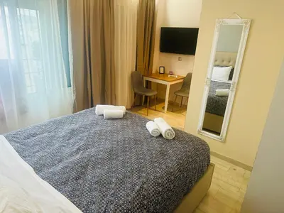 a hotel room with a bed and a mirror at Royal Red suite No2 PIRAEUS PORT in Piraeus