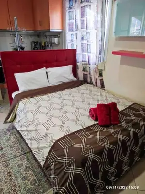 a bedroom with a large bed with red shoes on it at Spacious private rooftop studio, mountain and sea view in Athens