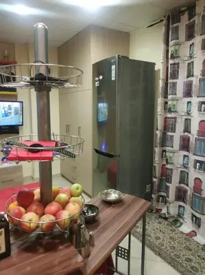 a kitchen with a bowl of fruit on a table at Spacious private rooftop studio, mountain and sea view in Athens