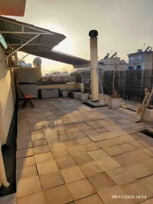 a rooftop with a tile floor on a building at Spacious private rooftop studio, mountain and sea view in Athens