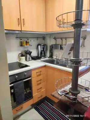 a small kitchen with a stove and a sink at Spacious private rooftop studio, mountain and sea view in Athens